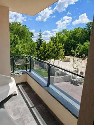 a balcony with a view of a park at Grabak B3 in Vrnjačka Banja