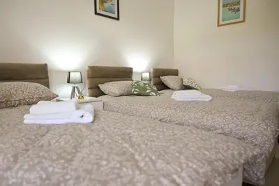 two beds sitting next to each other with towels on them at Apartmani kod kumašina in Kuršumlija