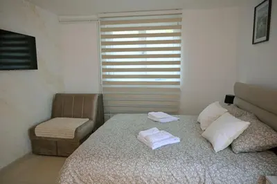 a bedroom with a bed with two towels on it at Apartmani kod kumašina in Kuršumlija