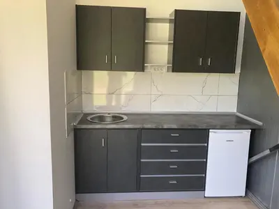 a small kitchen with black cabinets and a sink at Milosev Konak