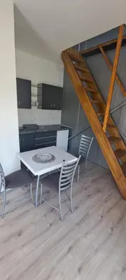 a table and chairs in a room with a kitchen at Milosev Konak