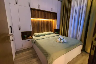 a bedroom with a bed with two stuffed animals on it at Harmonia Lux Aqua park in Jagodina