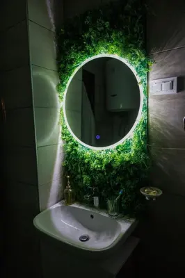 a bathroom with a mirror and a sink with green plants at Harmonia Lux Aqua park in Jagodina