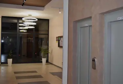 an office lobby with a door and a hallway at Zeus Apartman in Jagodina