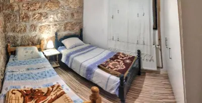 a bedroom with two twin beds and a window at Apartman Borići - nostalgija in Soko Banja