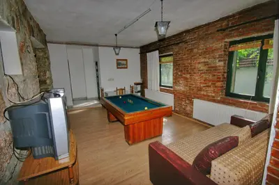 a living room with a pool table and a tv at Apartman Borići - nostalgija in Soko Banja