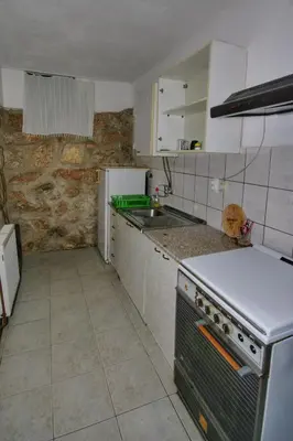 a kitchen with a sink and a stove top oven at Apartman Borići - nostalgija in Soko Banja