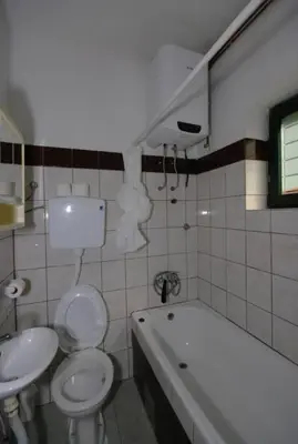a bathroom with a toilet and a sink and a tub at Apartman Borići - nostalgija in Soko Banja