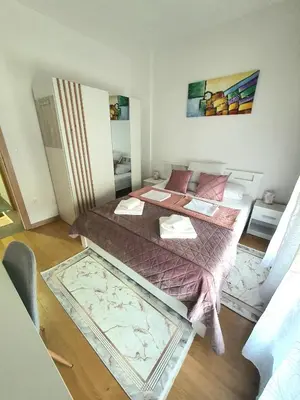 a bedroom with a large bed in a room at Family Lux Raj in Vrnjačka Banja