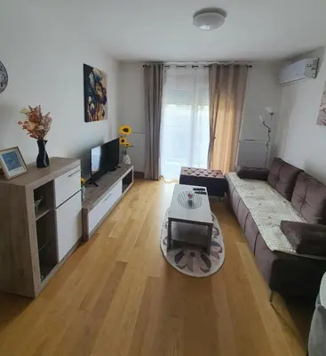 a living room with a couch and a table at Family Lux Raj in Vrnjačka Banja