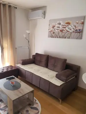 a living room with a couch and a table at Family Lux Raj in Vrnjačka Banja