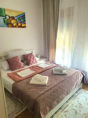 a bedroom with a bed with two towels on it at Family Lux Raj in Vrnjačka Banja