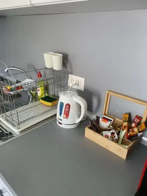 a kitchen counter with a dish drying rack and a coffee mug at Family Lux Raj in Vrnjačka Banja