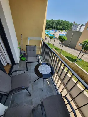 a balcony with chairs and a table on a balcony at Family Lux Raj in Vrnjačka Banja