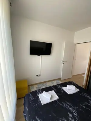 a room with a bed with two white towels on it at Rajsko sunce in Vrnjačka Banja