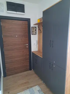 a room with a closet with a wooden door at Rajsko sunce in Vrnjačka Banja