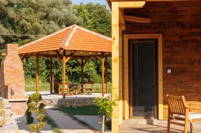 a wooden gazebo with a table and chairs at Brvnara Dadi
