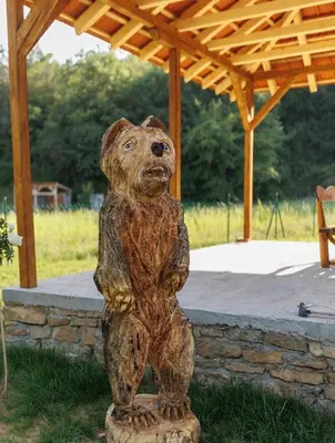 a statue of a bear standing on a stump at Brvnara Dadi