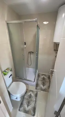 a small bathroom with a shower and a toilet at Vrnjačka View apartments in Vrnjačka Banja