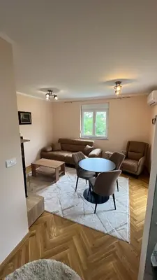 a living room with a table and a couch at Vrnjačka View apartments in Vrnjačka Banja
