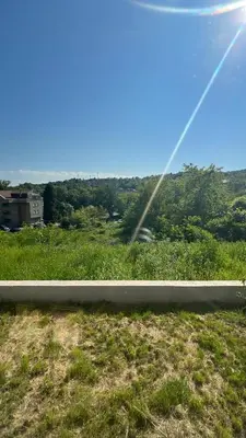 a view of a field of grass with the sun at Vrnjačka View apartments in Vrnjačka Banja
