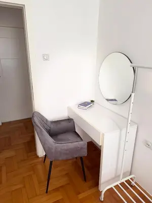 a dressing table with a mirror and a chair at DarViva Apartment Niš, center, private garage parking, river view in Niš