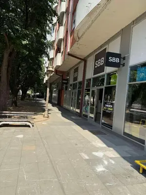 an empty sidewalk in front of a building at DarViva Apartment Niš, center, private garage parking, river view in Niš
