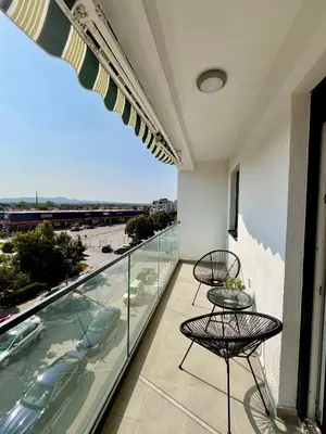 a balcony with chairs and a view of the ocean at Kalamata apartman, K Kompleks Jagodina in Trnava