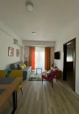 a living room with a couch and a table at Kalamata apartman, K Kompleks Jagodina in Trnava