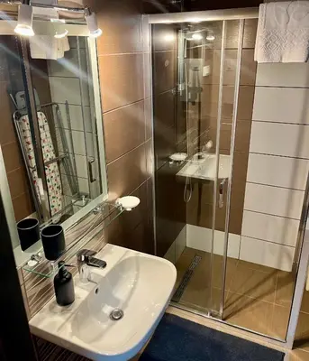 a bathroom with a sink and a shower at Kalamata apartman, K Kompleks Jagodina in Trnava