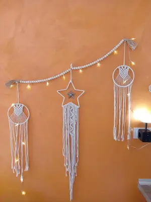 a string of dreamcatchers hanging on a wall at Apartmani Slatinska Oaza in Vrnjačka Banja