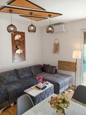 a living room with a couch and a table at Apartmani Slatinska Oaza in Vrnjačka Banja