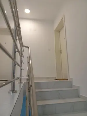 a staircase in a white room with a door at Apartmani Slatinska Oaza in Vrnjačka Banja