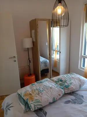 a bedroom with a bed and a large mirror at Apartmani Slatinska Oaza in Vrnjačka Banja