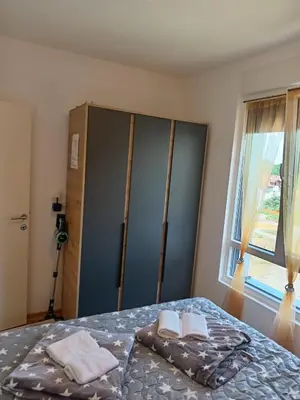 a bedroom with a bed with two towels on it at Apartmani Slatinska Oaza in Vrnjačka Banja