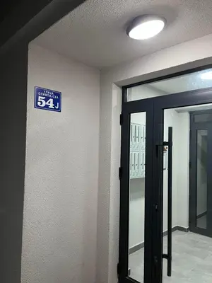 a blue sign on a wall next to a door at Gudzic in Vrnjci