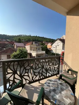 a balcony with a table and chairs and a view at Kika in Prokuplje