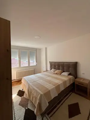 a bedroom with a large bed in a room at Kika in Prokuplje