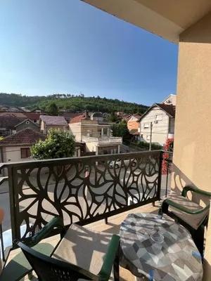a balcony with chairs and a table and a view at Kika in Prokuplje