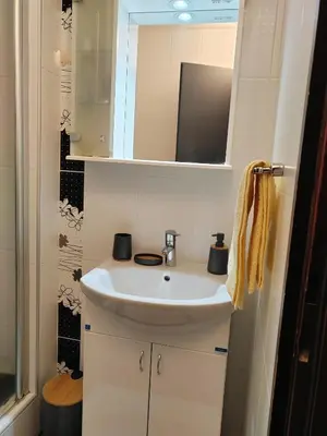 a bathroom with a white sink and a mirror at Kopaonik centar - Konaci, lux apartment ANDREA in Kopaonik