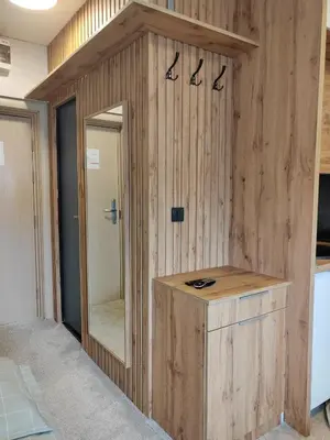 a bathroom with a wooden wall with a mirror at Kopaonik centar - Konaci, lux apartment ANDREA in Kopaonik