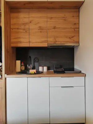 a kitchen with white cabinets and a sink at Kopaonik centar - Konaci, lux apartment ANDREA in Kopaonik