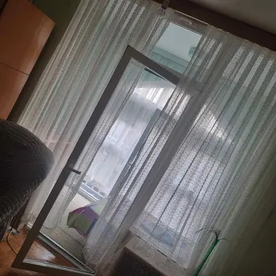 a window with white curtains and a lamp at Apartman Mina in Vrnjačka Banja