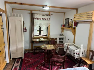 a living room with a table and a desk at Etno kuća Danica in Senje
