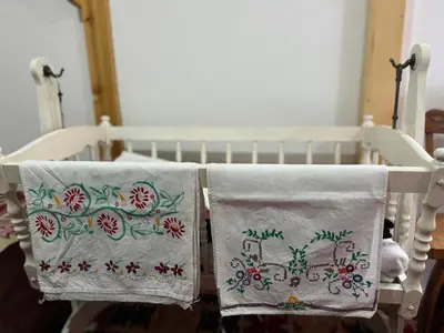 two towels are sitting on a crib at Etno kuća Danica in Senje