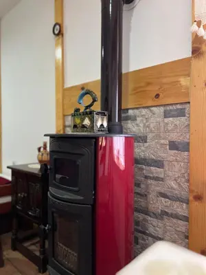 a stove in a kitchen with a brick wall at Etno kuća Danica in Senje