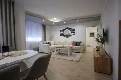a living room with a couch and a table at Apartmani Lepojevic in Prokuplje