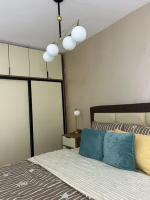 a bedroom with a bed with blue pillows on it at Ljubičica deluxe 2, sa dvorištem i parkingom in Vrnjačka Banja