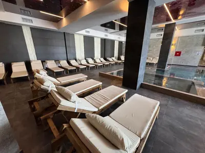 a waiting room with chairs and a swimming pool at Raccoon Paradise Apartment Residence Hill B19 in Kopaonik
