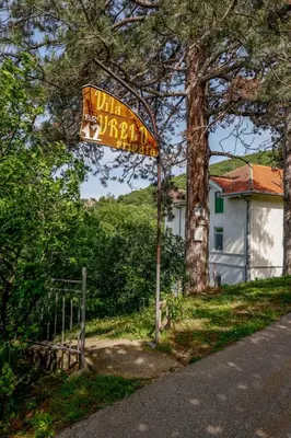 a sign on the side of a road next to a tree at Ilić Sokobanja in Soko Banja